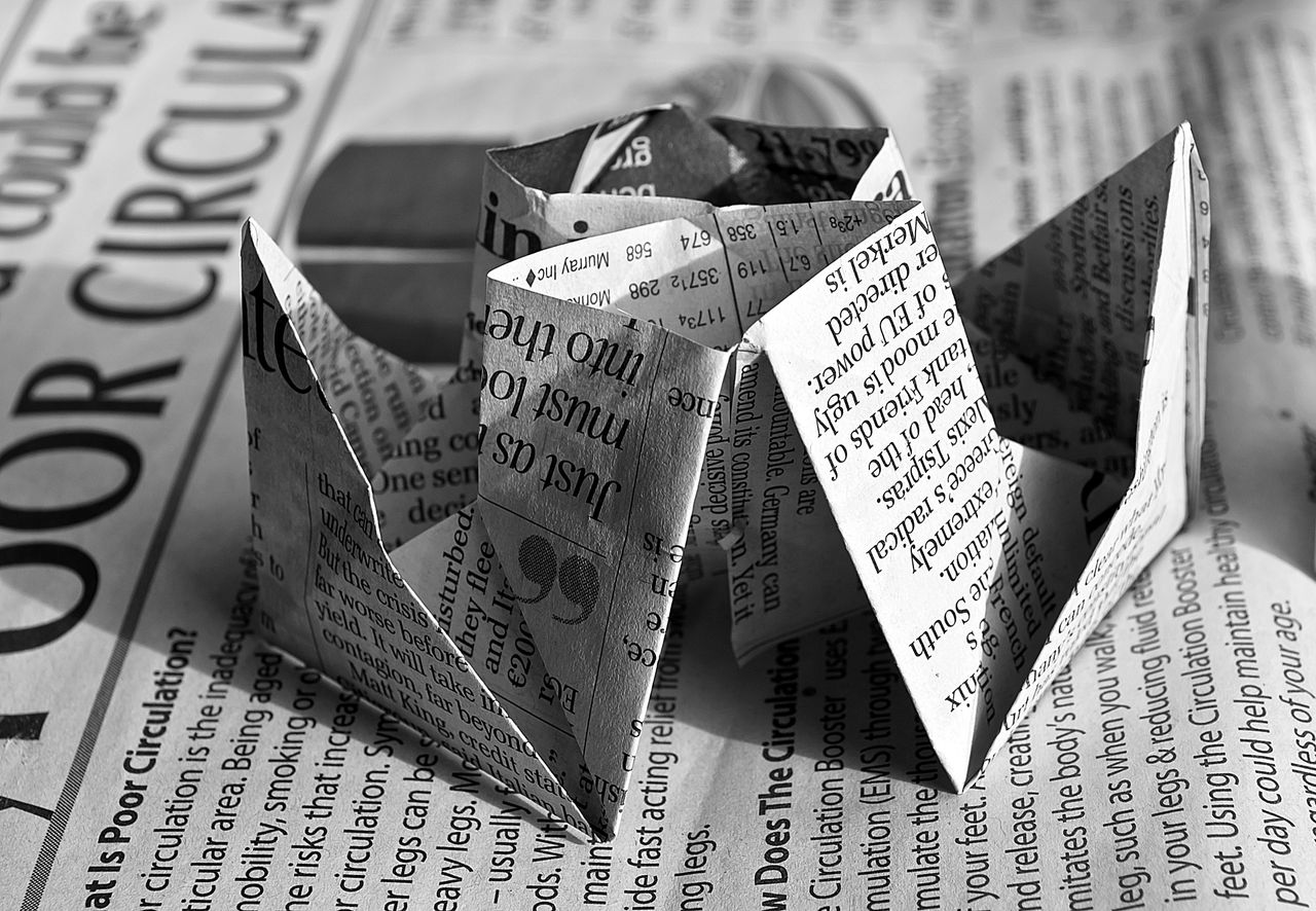 The Art of Drawing Readers In: Your attractive post title goes here Black and white origami rose crafted from newspaper text, showcasing artistic creativity.